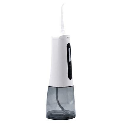 Hydropulseur compact Nomad Integra Flow en utilisation, montrant la puissance du jet d'eau pour le nettoyage interdentaire.
